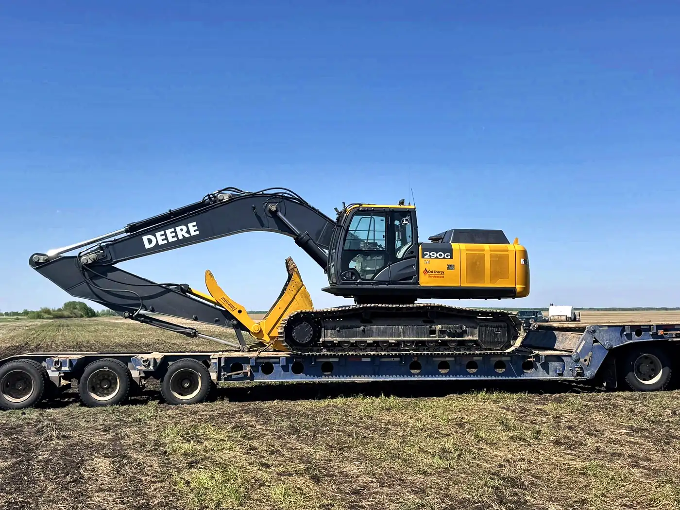 Ôsi Energy John Deere 290G excavator loaded on a lowbed trailer for heavy haul