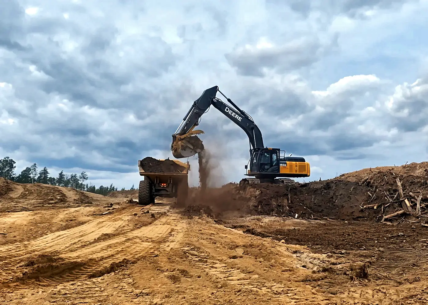 Excavator loading a truck on a reclamation site